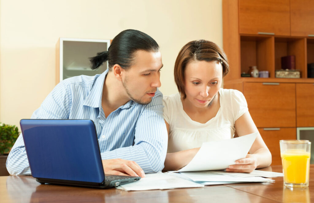 Clients reviewing and signing paperwork with assistance for notary public services in Hollywood, FL