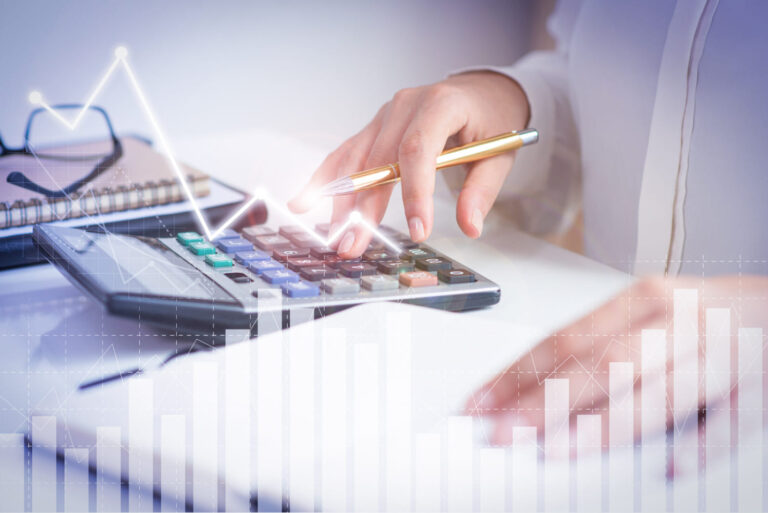 Tax professional calculating returns and reviewing data for tax preparation services in Hollywood, FL