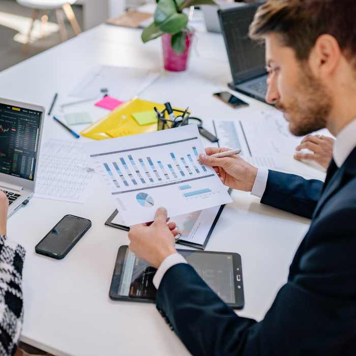 Financial advisor reviewing documents and calculations for business tax planning services in Hollywood, FL